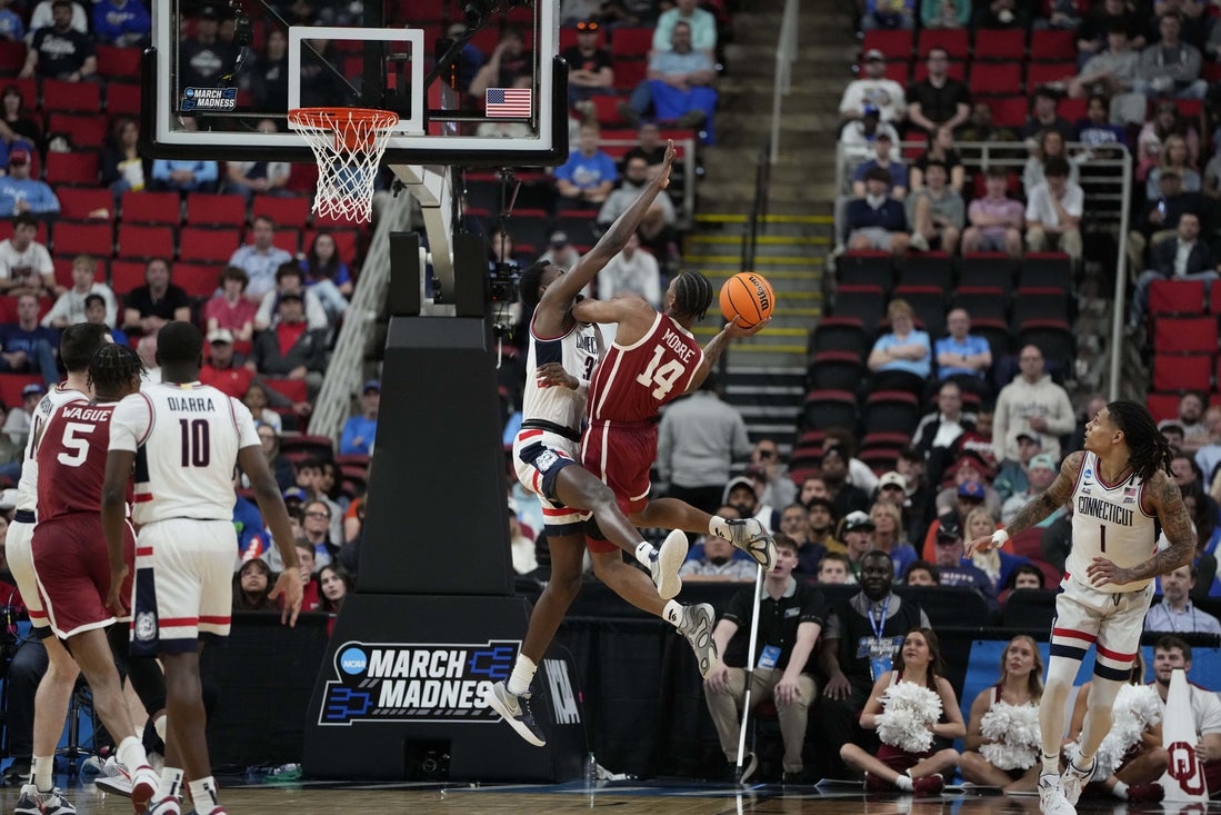 Mar 21, 2025; Raleigh, NC, USA; Connecticut Huskies forward Jaylin Stewart (3) defends against Oklahoma Sooners forward Jalon Moore (14) during the second half at Lenovo Center. Mandatory Credit: Bob Donnan-Imagn Images
