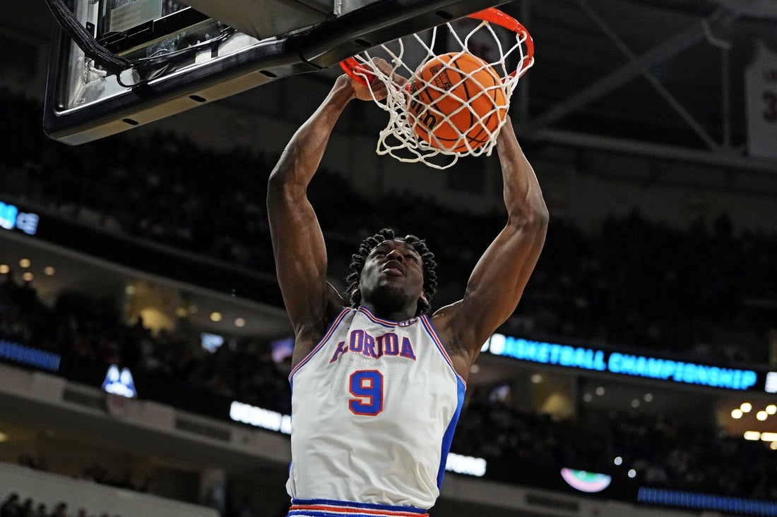 Mar 23, 2025; Raleigh, NC, USA; Florida Gators center Rueben Chinyelu (9) dunks the ball during the second half against the Connecticut Huskies in the second round of the NCAA Tournament at Lenovo Center. Mandatory Credit: Bob Donnan-Imagn Images