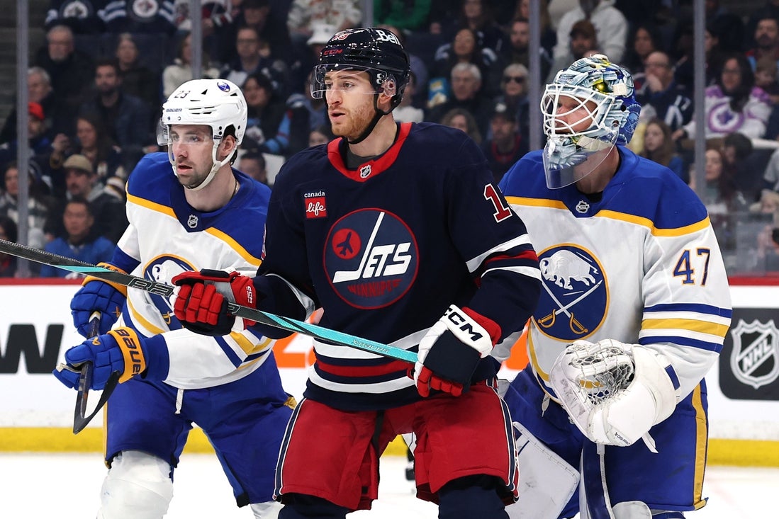 Mar 23, 2025; Winnipeg, Manitoba, CAN; Buffalo Sabres defenseman Mattias Samuelsson (23), Winnipeg Jets center Gabriel Vilardi (13) and Buffalo Sabres goaltender James Reimer (47) wait for an incoming shot in the second period at Canada Life Centre. Mandatory Credit: James Carey Lauder-Imagn Images