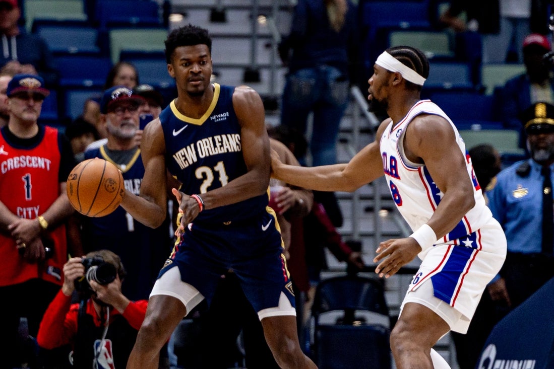 Mar 24, 2025; New Orleans, Louisiana, USA; New Orleans Pelicans center Yves Missi (21) passes the ball around Philadelphia 76ers forward Chuma Okeke (18) during the first half at Smoothie King Center. Mandatory Credit: Stephen Lew-Imagn Images