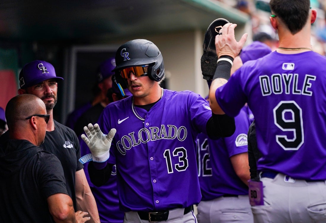 Colorado Rockies outfielder Zac Veen (13) celebrates after scoring during a spring training game against the Minnesota Twins at Lee Health Sports Complex in Fort Myers, Fla., on Tuesday, March 25, 2025.