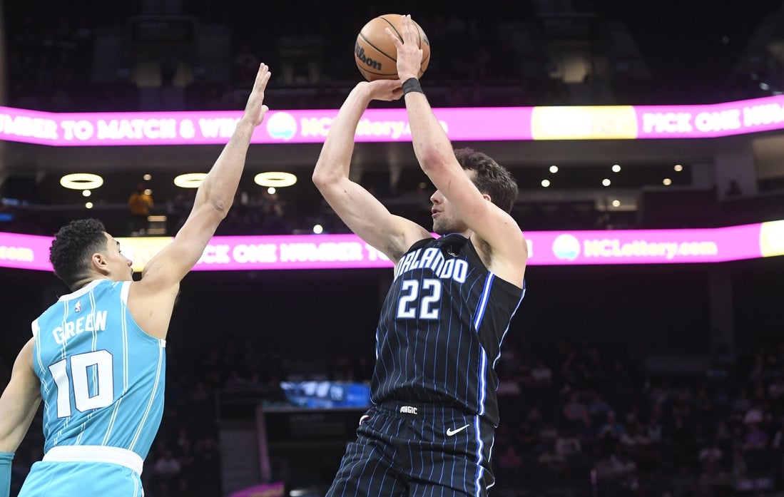 Mar 25, 2025; Charlotte, North Carolina, USA; Orlando Magic forward Franz Wagner (22) shoots over Charlotte Hornets guard Josh Green (10) during the first half at the Spectrum Center. Mandatory Credit: Sam Sharpe-Imagn Images