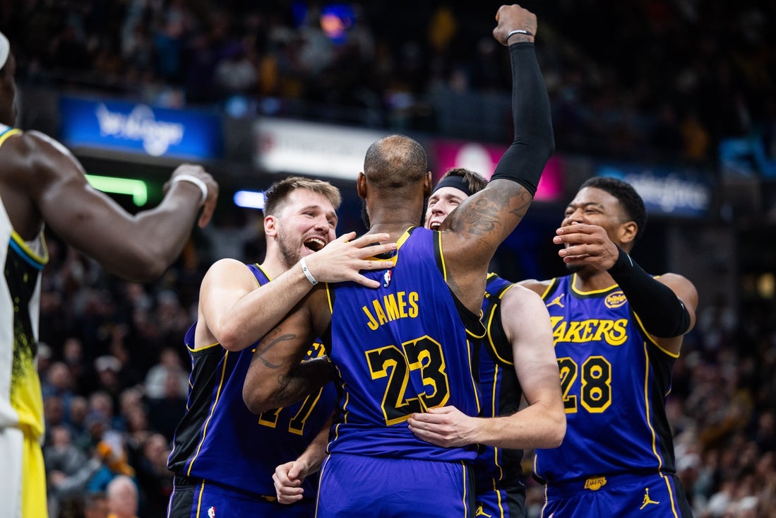 Mar 26, 2025; Indianapolis, Indiana, USA; Los Angeles Lakers forward LeBron James (23) celebrates his game winning shot against the Indiana Pacers with teammates at Gainbridge Fieldhouse. Mandatory Credit: Trevor Ruszkowski-Imagn Images