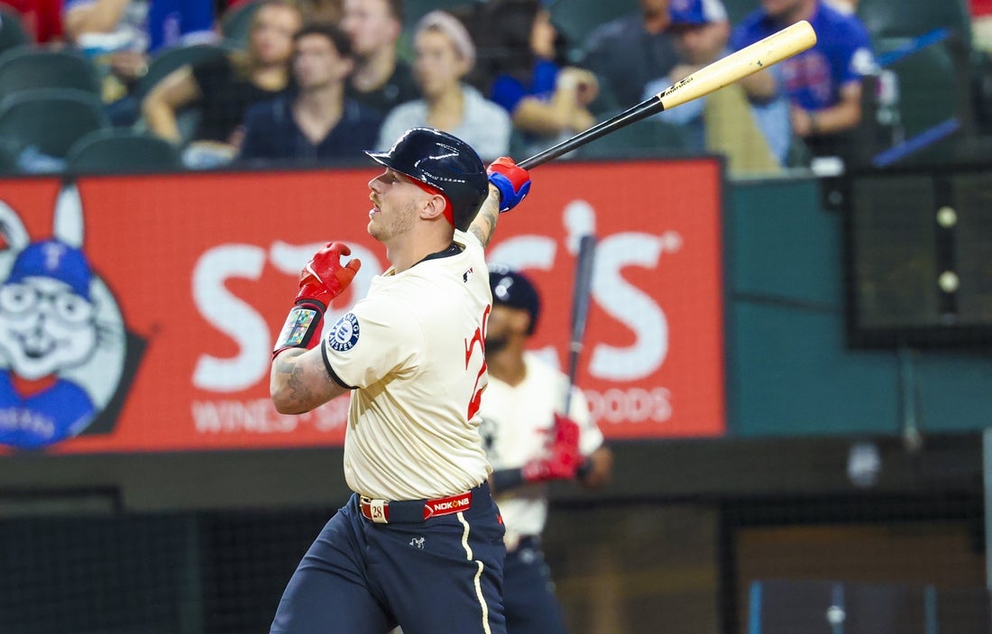 Mar 28, 2025; Arlington, Texas, USA; Texas Rangers catcher Jonah Heim (28) hits a home run during the third inning against the Boston Red Sox at Globe Life Field. Mandatory Credit: Kevin Jairaj-Imagn Images
