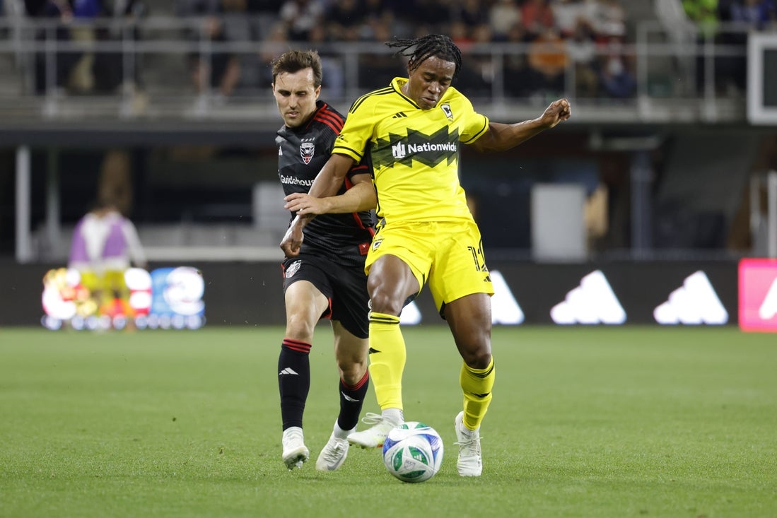 Mar 29, 2025; Washington, District of Columbia, USA; D.C. United midfielder Jared Stroud (8) battles for the ball with Columbus Crew forward DeJuan Jones (12) during the first half at Audi Field. Mandatory Credit: Amber Searls-Imagn Images
