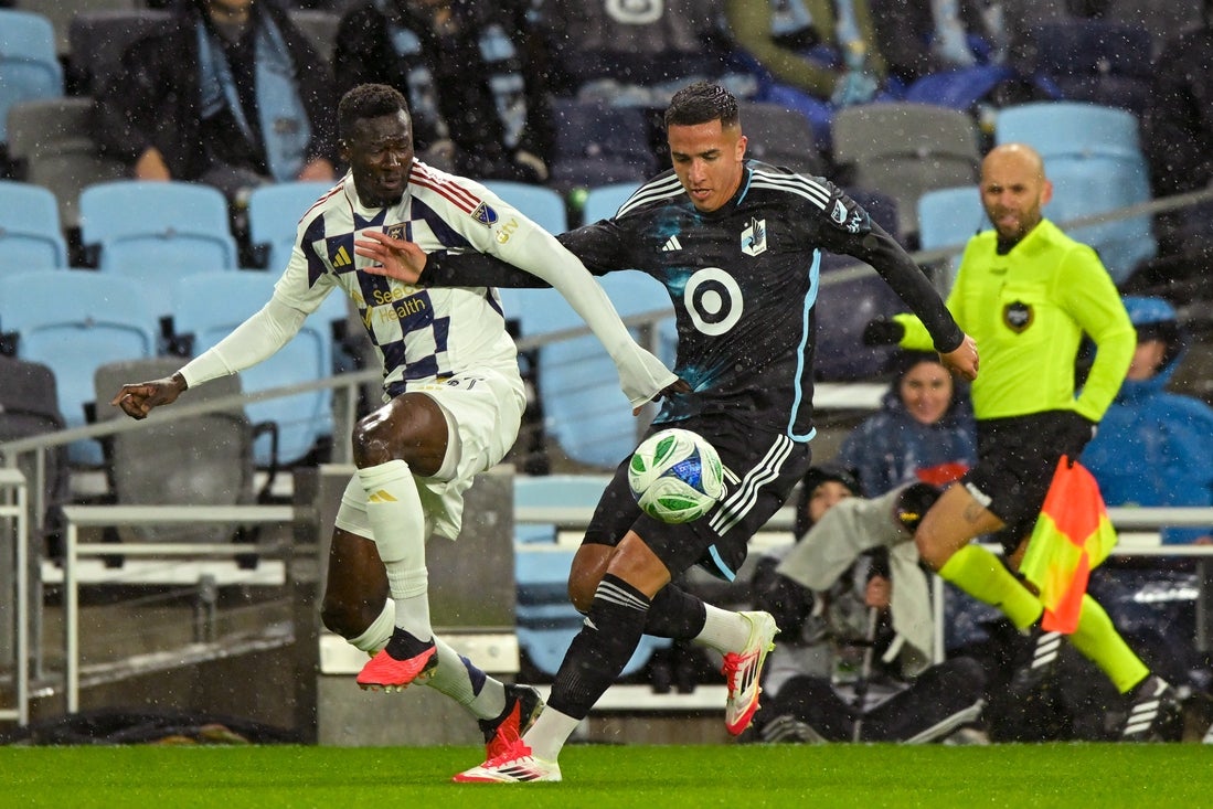 Mar 29, 2025; Saint Paul, Minnesota, USA; Real Salt Lake forward Forster Ajago (27) and Minnesota United defender Nicolas Romero (5) battle for the ball during the first half at Allianz Field. Mandatory Credit: Nick Wosika-Imagn Images