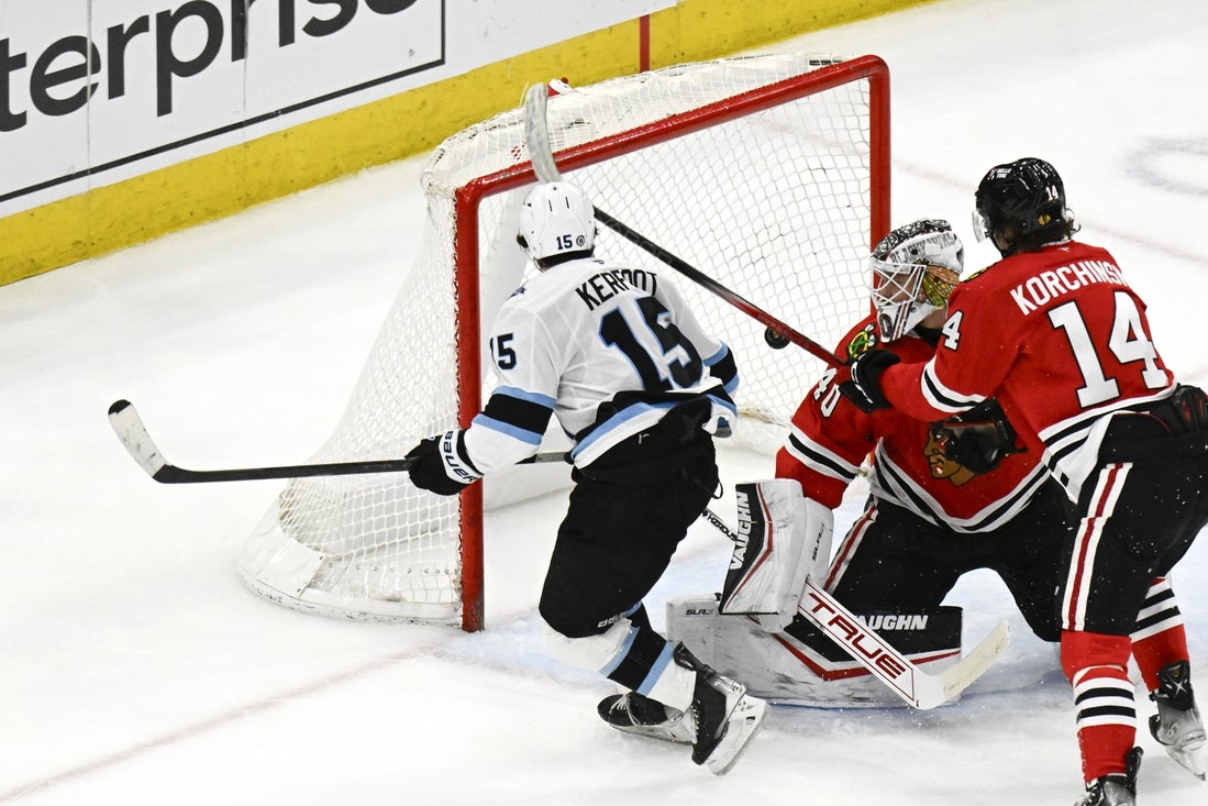 Mar 30, 2025; Chicago, Illinois, USA; Utah Hockey Club center Alexander Kerfoot (15) scores against Chicago Blackhawks goaltender Arvid Soderblom (40) during the second period at United Center. Mandatory Credit: Matt Marton-Imagn Images