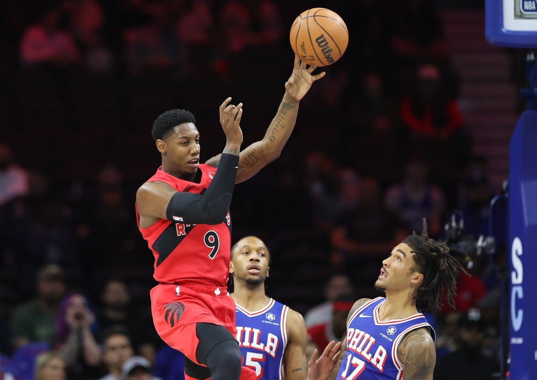 Mar 30, 2025; Philadelphia, Pennsylvania, USA; Toronto Raptors guard RJ Barrett (9) passes the ball past Philadelphia 76ers guard Jalen Hood-Schifino (17) during the first quarter at Wells Fargo Center. Mandatory Credit: Bill Streicher-Imagn Images