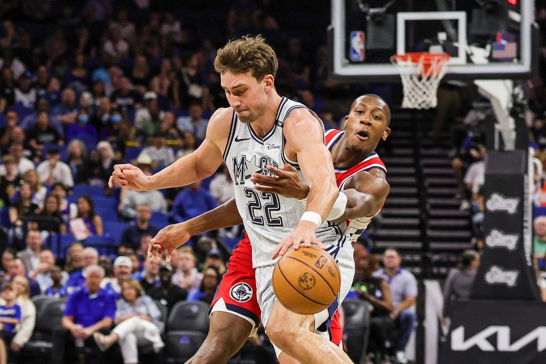 Mar 31, 2025; Orlando, Florida, USA; LA Clippers guard Kris Dunn (8) defends Orlando Magic forward Franz Wagner (22) during the first quarter at Kia Center. Mandatory Credit: Mike Watters-Imagn Images