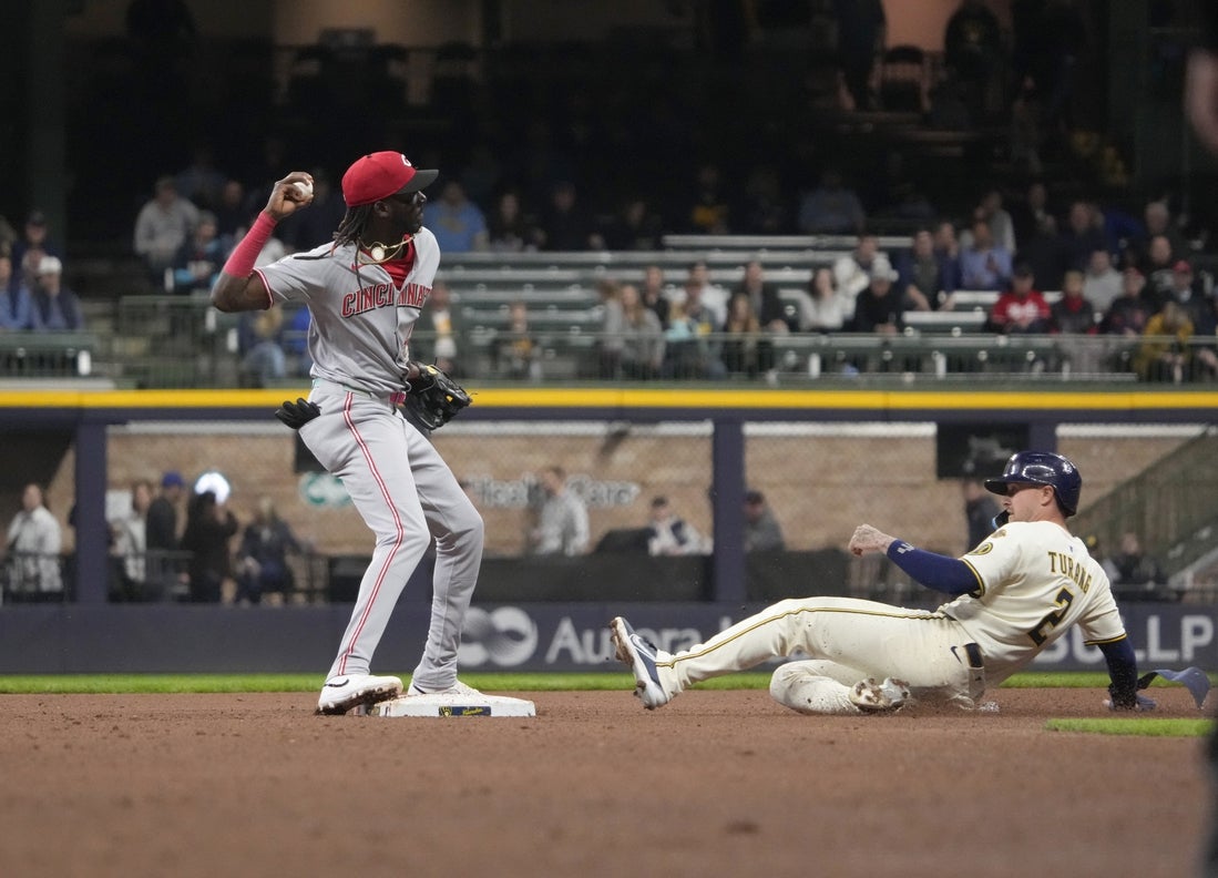 Apr 3, 2025; Milwaukee, Wisconsin, USA; Cincinnati Reds shortstop Elly De La Cruz (44) throws the ball to first base as he forces out Milwaukee Brewers second baseman Brice Turang (2) and completes the double play at American Family Field. Mandatory Credit: Michael McLoone-Imagn Images