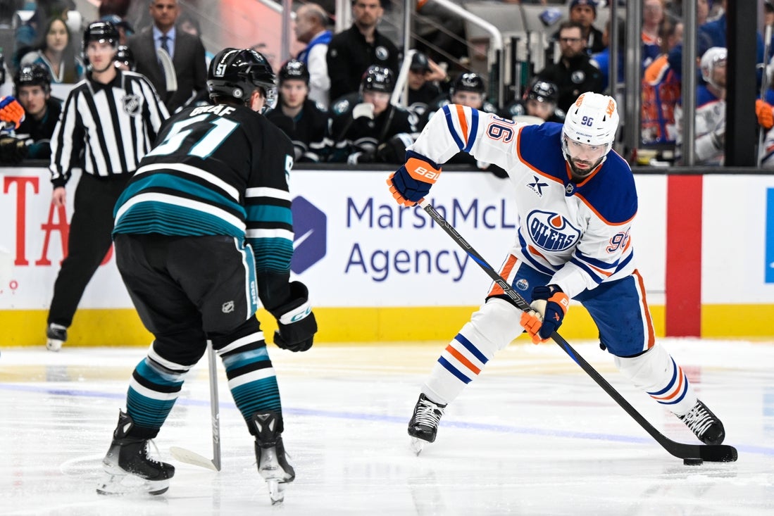 Apr 3, 2025; San Jose, California, USA; Edmonton Oilers defenseman Jake Walman (96) controls the puck against San Jose Sharks right wing Collin Graf (51) in the first period at SAP Center at San Jose. Mandatory Credit: Eakin Howard-Imagn Images