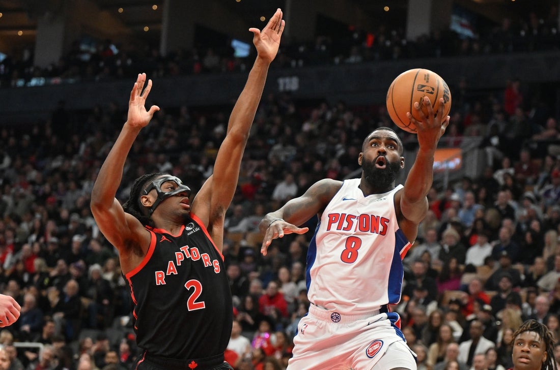 Apr 4, 2025; Toronto, Ontario, CAN; Detroit Pistons guard Tim Hardaway Jr. (8) shoots the ball against Toronto Raptors forward Jonathan Mogbo (2) in the first half at Scotiabank Arena. Mandatory Credit: Dan Hamilton-Imagn Images