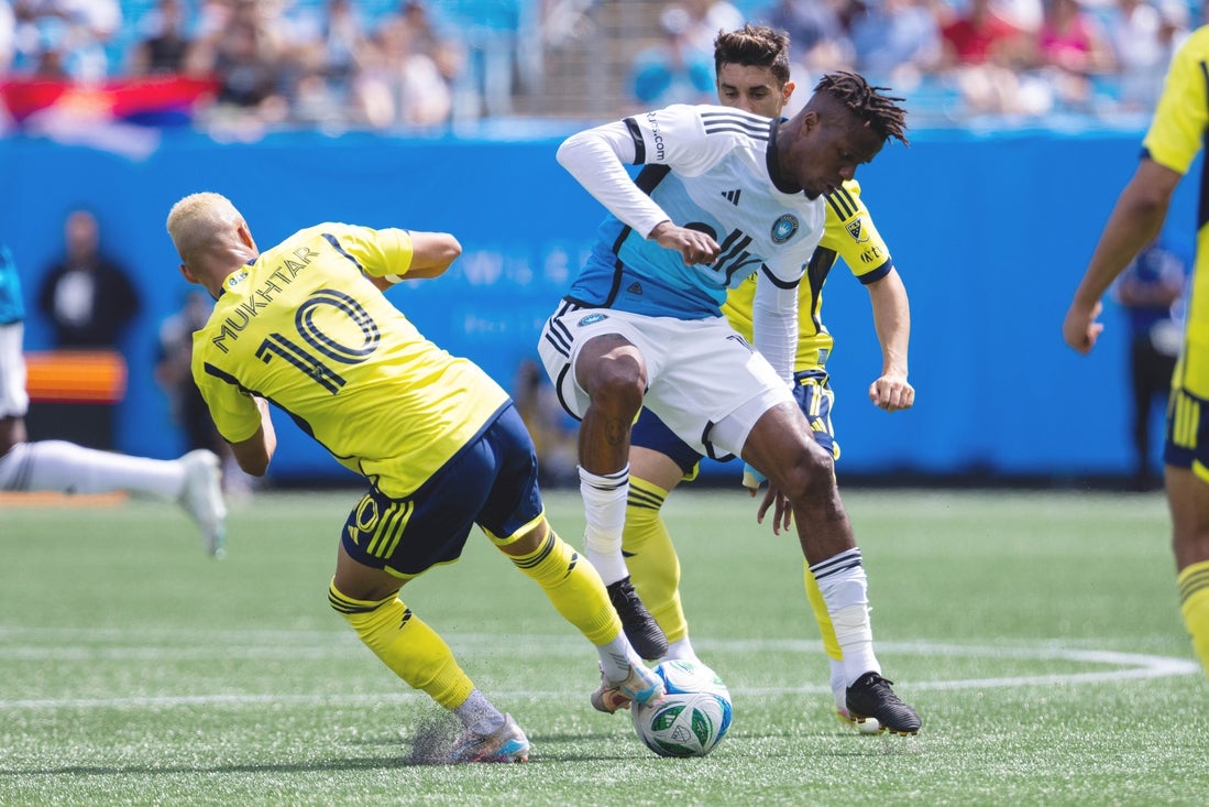 Apr 5, 2025; Charlotte, North Carolina, USA; Charlotte FC forward Wilfried Zaha (10) and Nashville SC midfielder Hany Mukhtar (10) battle during the first half at Bank of America Stadium. Mandatory Credit: Scott Kinser-Imagn Images