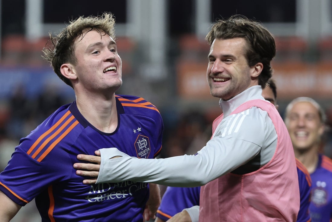 Apr 5, 2025; Houston, Texas, USA; Houston Dynamo FC defender Ethan Bartlow (4) celebrates midfielder Jack McGlynn's (21) goal against the Los Angeles FC in the second half at Shell Energy Stadium. Mandatory Credit: Thomas Shea-Imagn Images