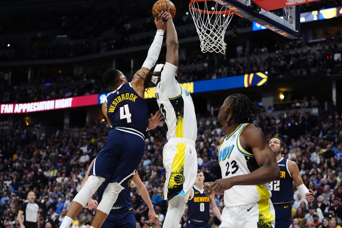 Apr 6, 2025; Denver, Colorado, USA; Denver Nuggets guard Russell Westbrook (4) fouls Indiana Pacers center Myles Turner (33) in the second quarter at Ball Arena. Mandatory Credit: Ron Chenoy-Imagn Images