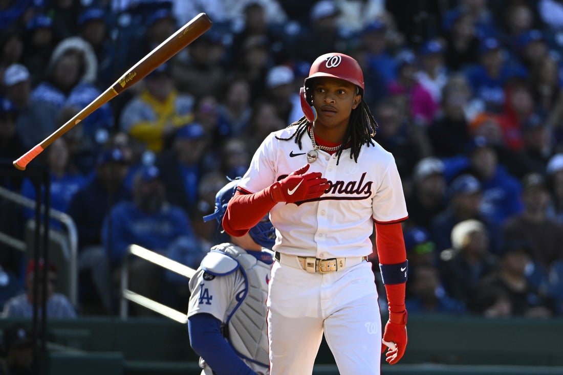 Apr 9, 2025; Washington, District of Columbia, USA; Washington Nationals shortstop CJ Abrams (5) flips his bat after hitting a solo home run against the Los Angeles Dodgers during the first inning at Nationals Park. Mandatory Credit: Brad Mills-Imagn Images
