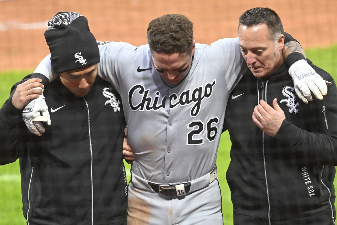 Apr 9, 2025; Cleveland, Ohio, USA; Chicago White Sox catcher Korey Lee (26) is helped to the dugout after he was injured while being picked off first base in the sixth inning against the Cleveland Guardians at Progressive Field. Mandatory Credit: David Richard-Imagn Images