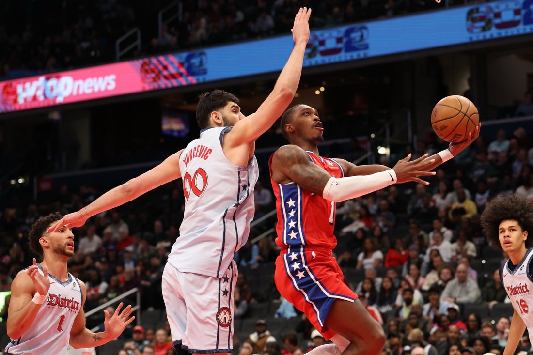 Apr 9, 2025; Washington, District of Columbia, USA; Philadelphia 76ers guard Lonnie Walker IV (16) shoots the ball as Washington Wizards forward Tristan Vukcevic (00) defends in the first half at Capital One Arena. Mandatory Credit: Geoff Burke-Imagn Images