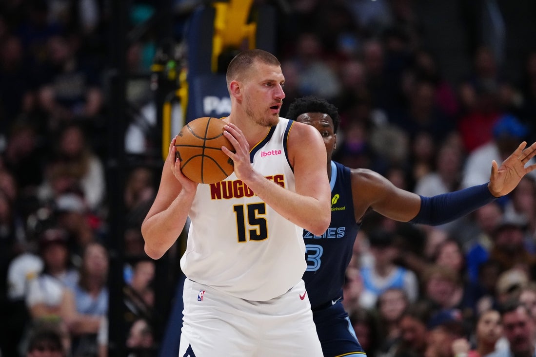 Apr 11, 2025; Denver, Colorado, USA; Memphis Grizzlies forward Jaren Jackson Jr. (13) defends Denver Nuggets center Nikola Jokic (15) in the first quarter at Ball Arena. Mandatory Credit: Ron Chenoy-Imagn Images
