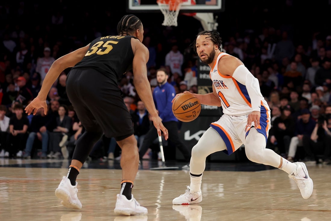 Apr 11, 2025; New York, New York, USA; New York Knicks guard Jalen Brunson (11) controls the ball against Cleveland Cavaliers forward Isaac Okoro (35) during the fourth quarter at Madison Square Garden. Mandatory Credit: Brad Penner-Imagn Images
