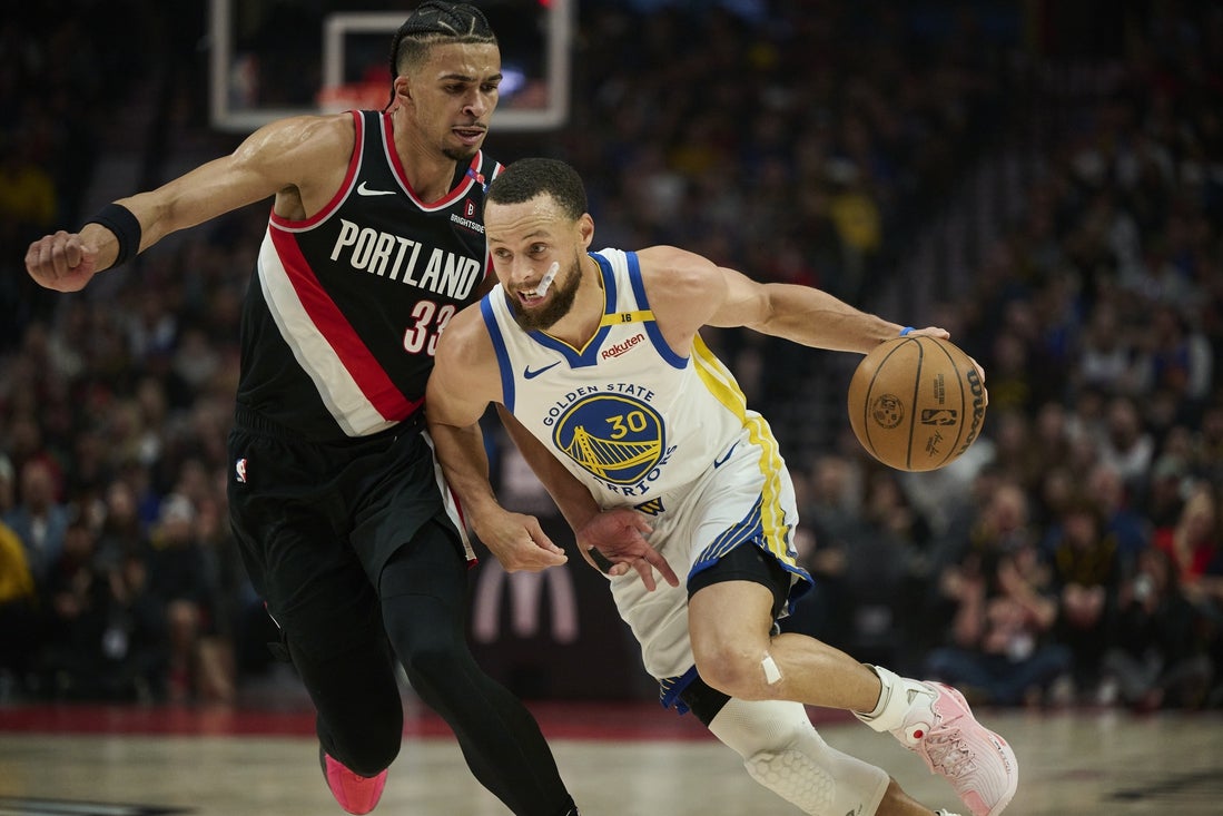 Apr 11, 2025; Portland, Oregon, USA; Golden State Warriors guard Stephen Curry (30) drives to the basket during the first half against Portland Trail Blazers forward Toumani Camara (33) at Moda Center. Mandatory Credit: Troy Wayrynen-Imagn Images