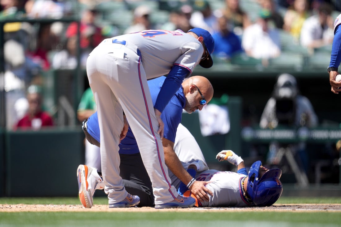Apr 12, 2025; West Sacramento, California, USA; New York Mets center fielder Jose Siri (19) lays on the ground after suffering an injury against the Athletics in the second inning at Sutter Health Park. Mandatory Credit: Cary Edmondson-Imagn Images