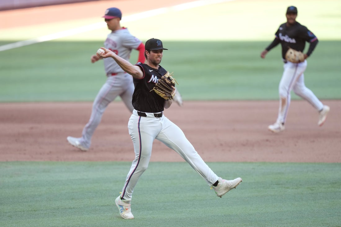 Apr 12, 2025; Miami, Florida, USA; Miami Marlins third baseman Graham Pauley (21) makes an off-balanced throw to first base for an out against the Washington Nationals in the fourth inning at loanDepot Park. Mandatory Credit: Jim Rassol-Imagn Images