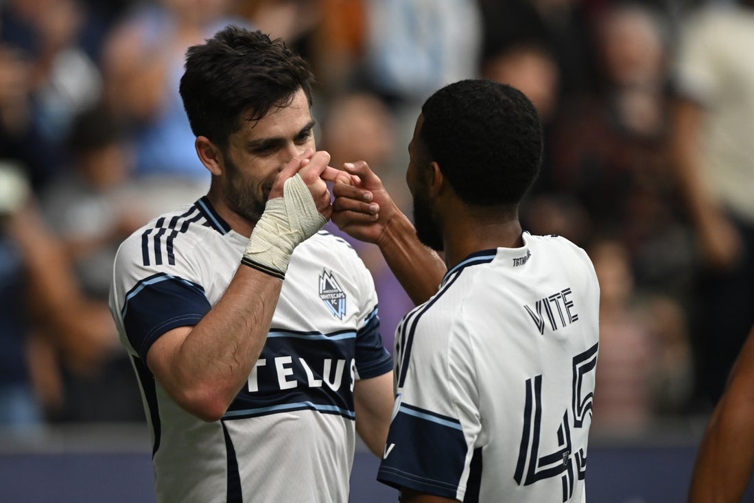 Apr 12, 2025; Vancouver, British Columbia, CAN; Vancouver Whitecaps FC forward Brian White (24) celebrates with midfielder Pedro Vite (45) after scoring against Austin FC during the first half at BC Place. Mandatory Credit: Anne-Marie Sorvin-Imagn Images