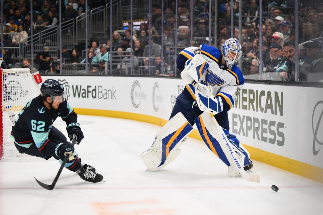 Apr 12, 2025; Seattle, Washington, USA; St. Louis Blues goaltender Jordan Binnington (50) passes the puck against the Seattle Kraken during the second period at Climate Pledge Arena. Mandatory Credit: Steven Bisig-Imagn Images