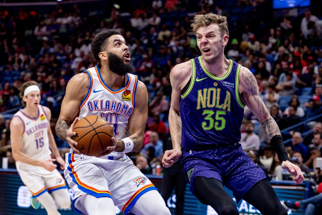Apr 13, 2025; New Orleans, Louisiana, USA; Oklahoma City Thunder forward Kenrich Williams (34) dribbles against New Orleans Pelicans center Kylor Kelley (35) during the first half at Smoothie King Center. Mandatory Credit: Stephen Lew-Imagn Images