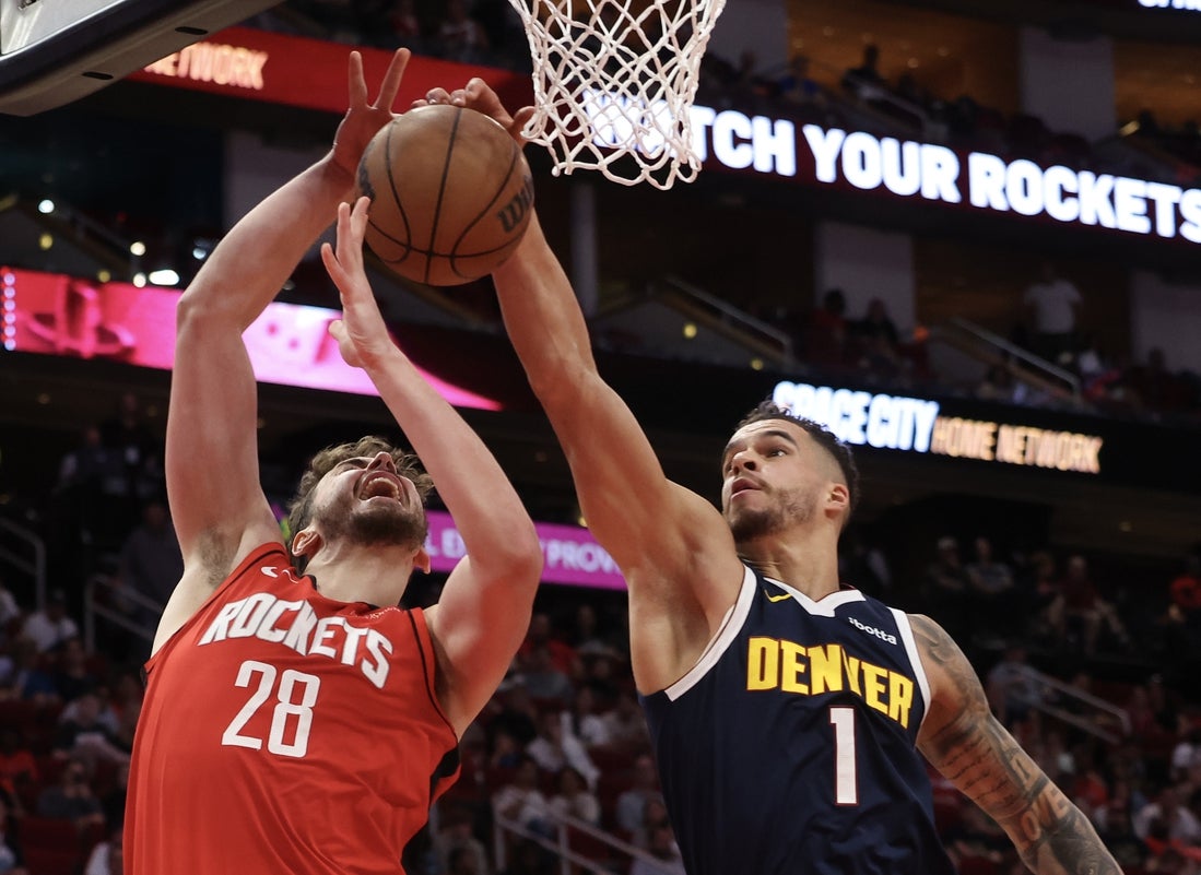 Apr 13, 2025; Houston, Texas, USA; Houston Rockets center Alperen Sengun (28) reaches for an offensive rebound against Denver Nuggets forward Michael Porter Jr. (1) in the second quarter at Toyota Center. Mandatory Credit: Thomas Shea-Imagn Images