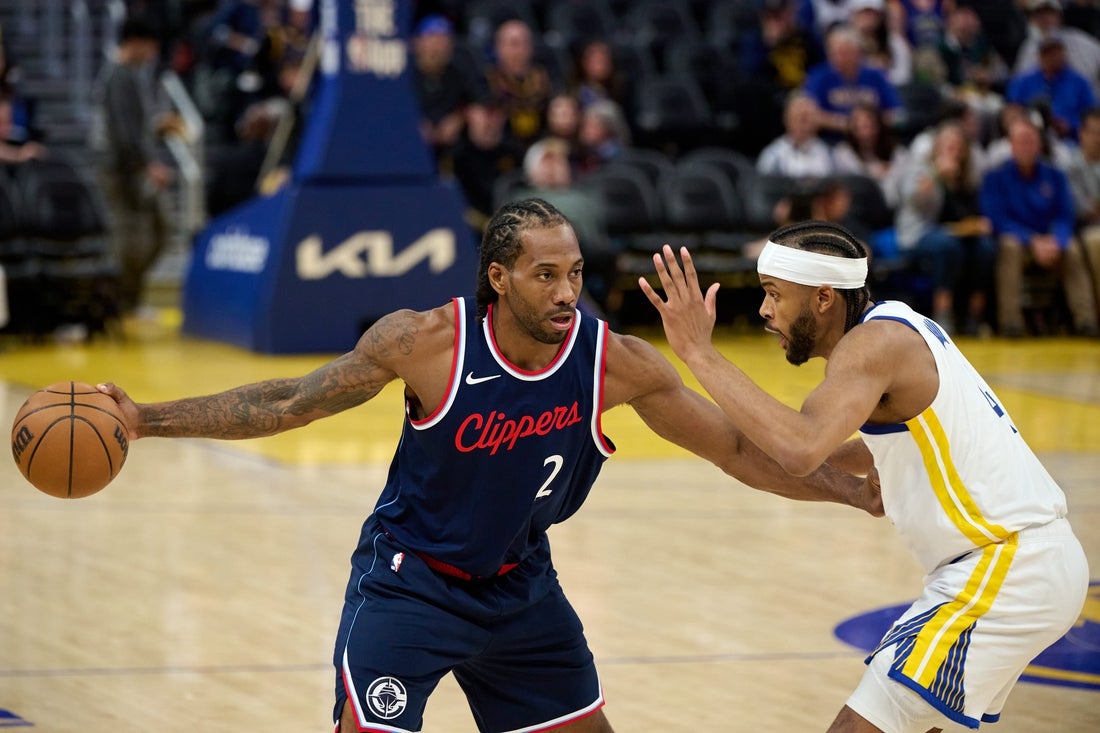 Apr 13, 2025; San Francisco, California, USA; LA Clippers forward Kawhi Leonard (2) controls the ball against Golden State Warriors guard Moses Moody (4) during the third quarter at Chase Center. Mandatory Credit: Robert Edwards-Imagn Images