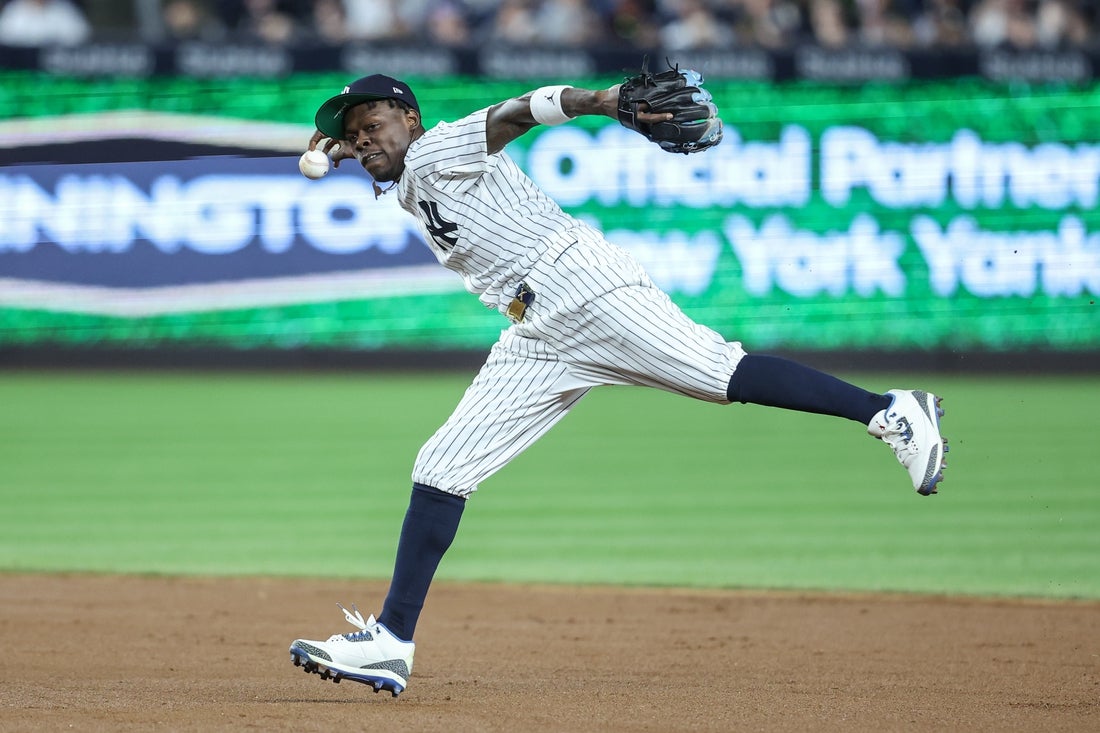 Apr 15, 2025; Bronx, New York, USA; New York Yankees second baseman Jazz Chisholm Jr. (13) tries to make a running throw to first base in the fifth inning against the Kansas City Royals at Yankee Stadium. All players wore #42 for Jackie Robinson Day. Mandatory Credit: Wendell Cruz-Imagn Images