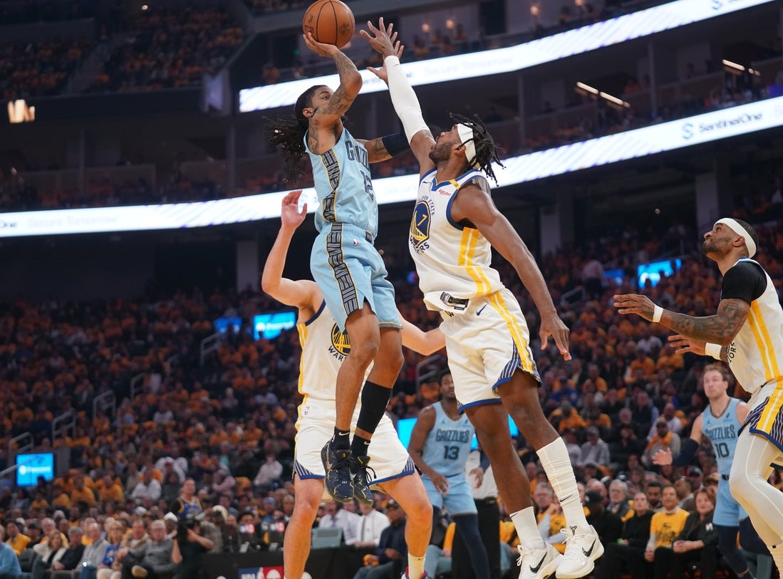 Apr 15, 2025; San Francisco, California, USA; Memphis Grizzlies guard Ja Morant (12) shoots over Golden State Warriors guard Buddy Hield (7) in the first quarter at the Chase Center. Mandatory Credit: Cary Edmondson-Imagn Images