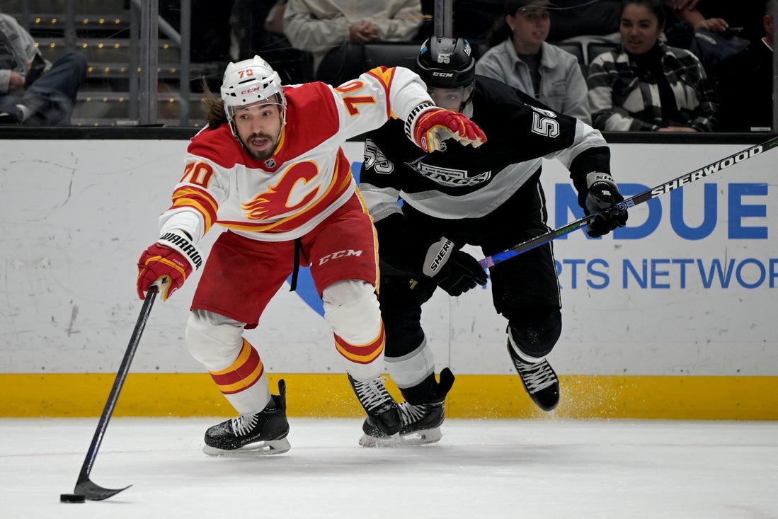 Apr 17, 2025; Los Angeles, California, USA; Calgary Flames left wing Ryan Lomberg (70) and Los Angeles Kings right wing Quinton Byfield (55) chase down the puck in the first period at Crypto.com Arena. Mandatory Credit: Jayne Kamin-Oncea-Imagn Images