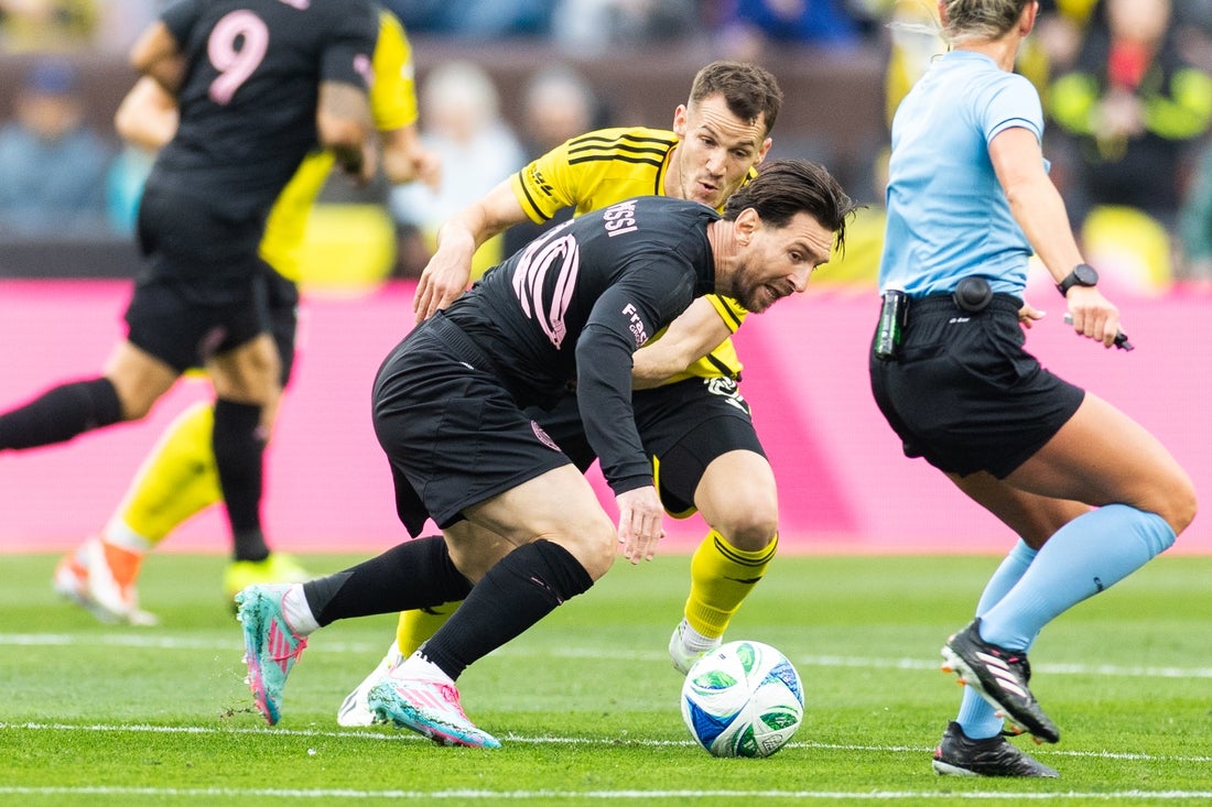 Apr 19, 2025; Cleveland, Ohio, USA; Inter Miami CF forward Lionel Messi (10) and Columbus Crew midfielder Daniel Gazdag (8) battle for the all during the first half at Huntington Bank Field. Mandatory Credit: Scott Galvin-Imagn Images