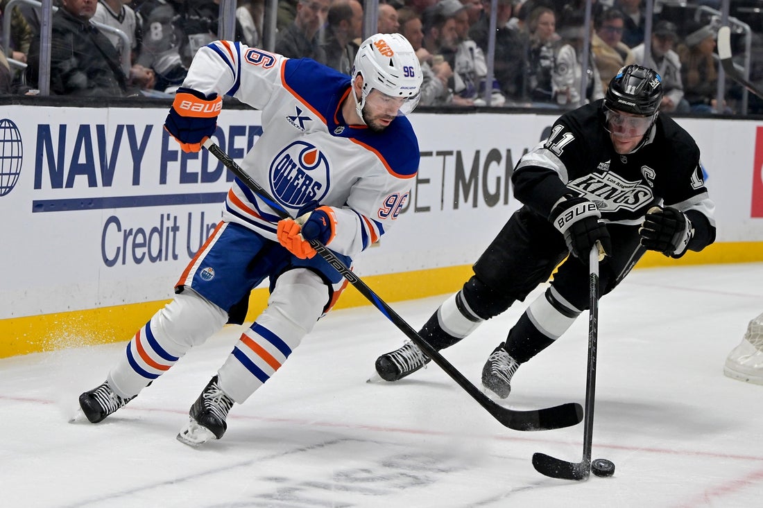 Apr 23, 2025; Los Angeles, California, USA; Edmonton Oilers defenseman Jake Walman (96) and Los Angeles Kings center Anze Kopitar (11) go for the puck in the first period of game 2 of the 2025 Stanley Cup Playoffs at Crypto.com Arena. Mandatory Credit: Jayne Kamin-Oncea-Imagn Images