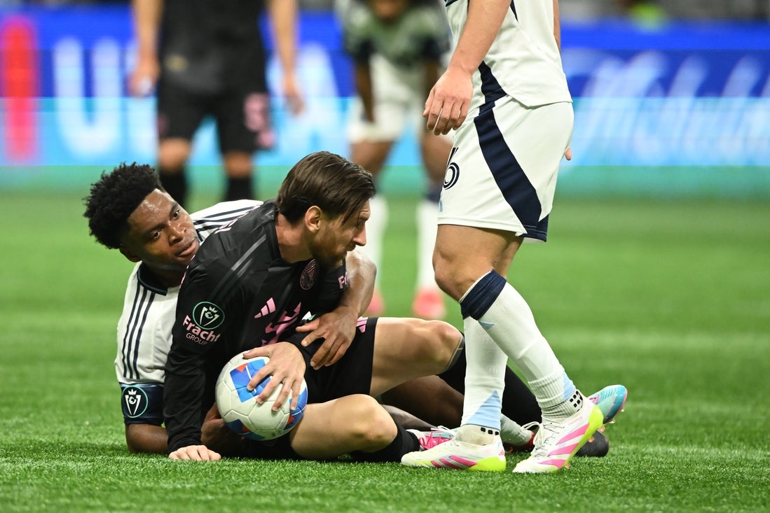 Apr 24, 2025; Vancouver, British Columbia, CAN; Vancouver Whitecaps FC midfielder Ralph Priso (13) fights for the ball against Inter Miami SC forward Lionel Messi (10)during the second half at BC Place. Mandatory Credit: Anne-Marie Sorvin-Imagn Images