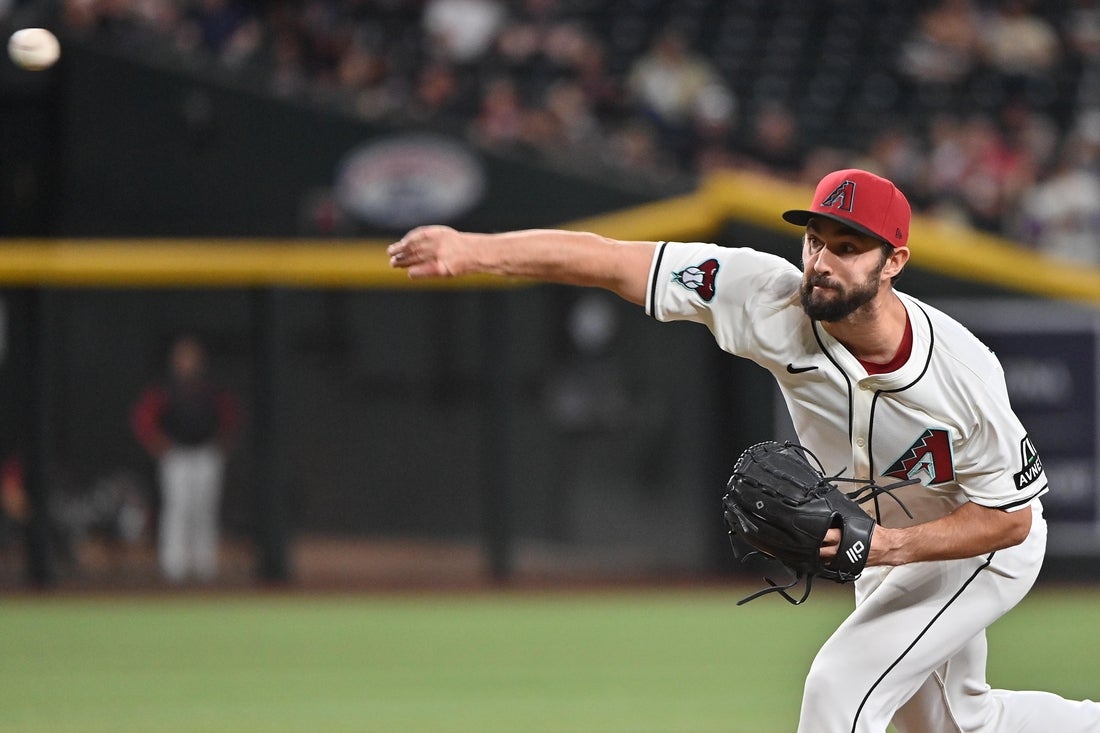 Apr 24, 2025; Phoenix, Arizona, USA; Arizona Diamondbacks pitcher J.P. Feyereisen (61) throws in the tenth inning against the Tampa Bay Rays at Chase Field. Mandatory Credit: Matt Kartozian-Imagn Images