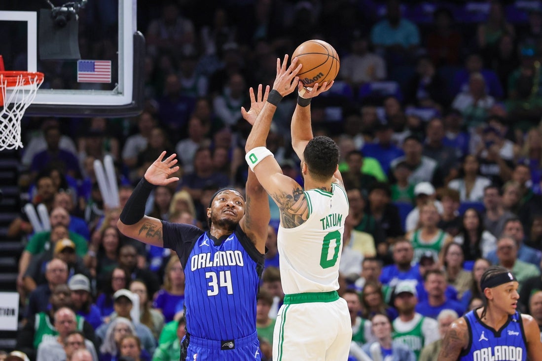 Apr 25, 2025; Orlando, Florida, USA; Boston Celtics forward Jayson Tatum (0) shoots against Orlando Magic center Wendell Carter Jr. (34) during the first quarter of game three of first round for the 2024 NBA Playoffs at Kia Center. Mandatory Credit: Mike Watters-Imagn Images
