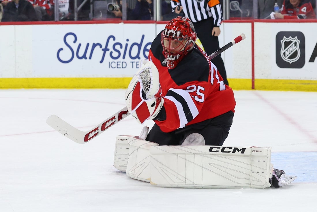 Apr 25, 2025; Newark, New Jersey, USA; New Jersey Devils goaltender Jacob Markstrom (25) makes a save against the Carolina Hurricanes during the first period in game three of the first round of the 2025 Stanley Cup Playoffs at Prudential Center. Mandatory Credit: Ed Mulholland-Imagn Images