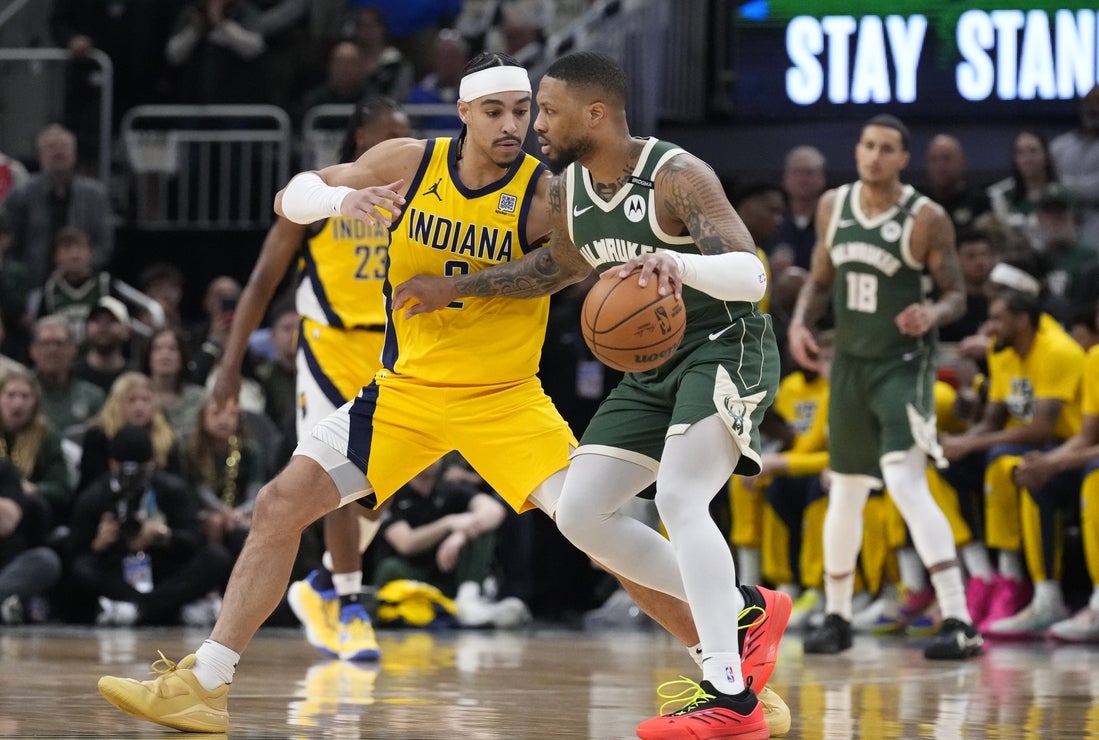 Apr 25, 2025; Milwaukee, Wisconsin, USA; Milwaukee Bucks guard Damian Lillard (0) drives against Indiana Pacers guard Andrew Nembhard (2) in the first half during game three of the first round for the 2024 NBA Playoffs at Fiserv Forum. Mandatory Credit: Michael McLoone-Imagn Images