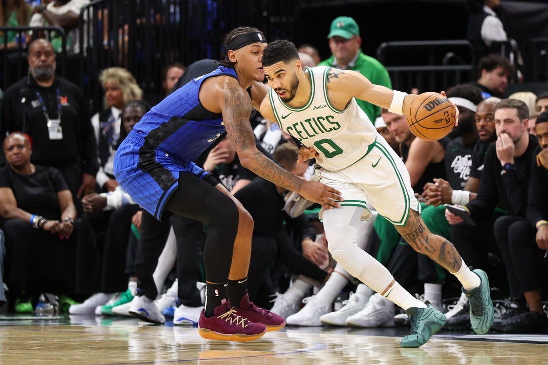 Apr 27, 2025; Orlando, Florida, USA; Boston Celtics forward Jayson Tatum (0) is guarded by Orlando Magic forward Paolo Banchero (5) in the second quarter during game four of first round for the 2025 NBA Playoffs at Kia Center. Mandatory Credit: Nathan Ray Seebeck-Imagn Images