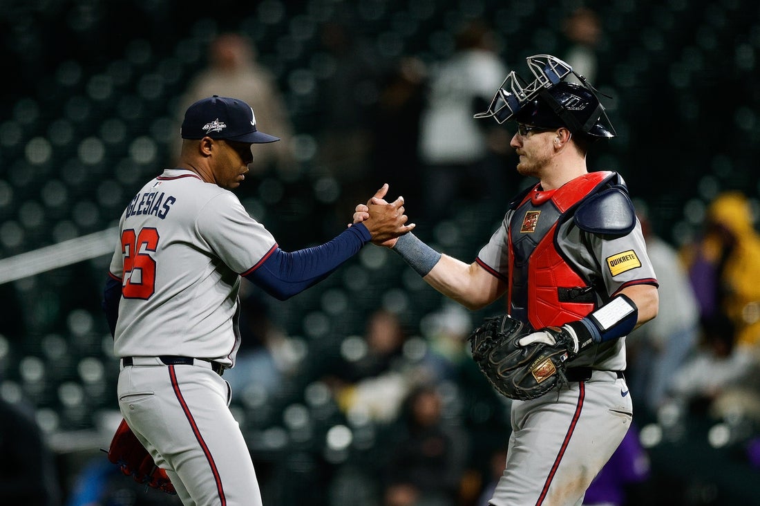 Apr 28, 2025; Denver, Colorado, USA; Atlanta Braves relief pitcher Raisel Iglesias (26) celebrates with catcher Sean Murphy (12) after the game against the Colorado Rockies at Coors Field. Mandatory Credit: Isaiah J. Downing-Imagn Images