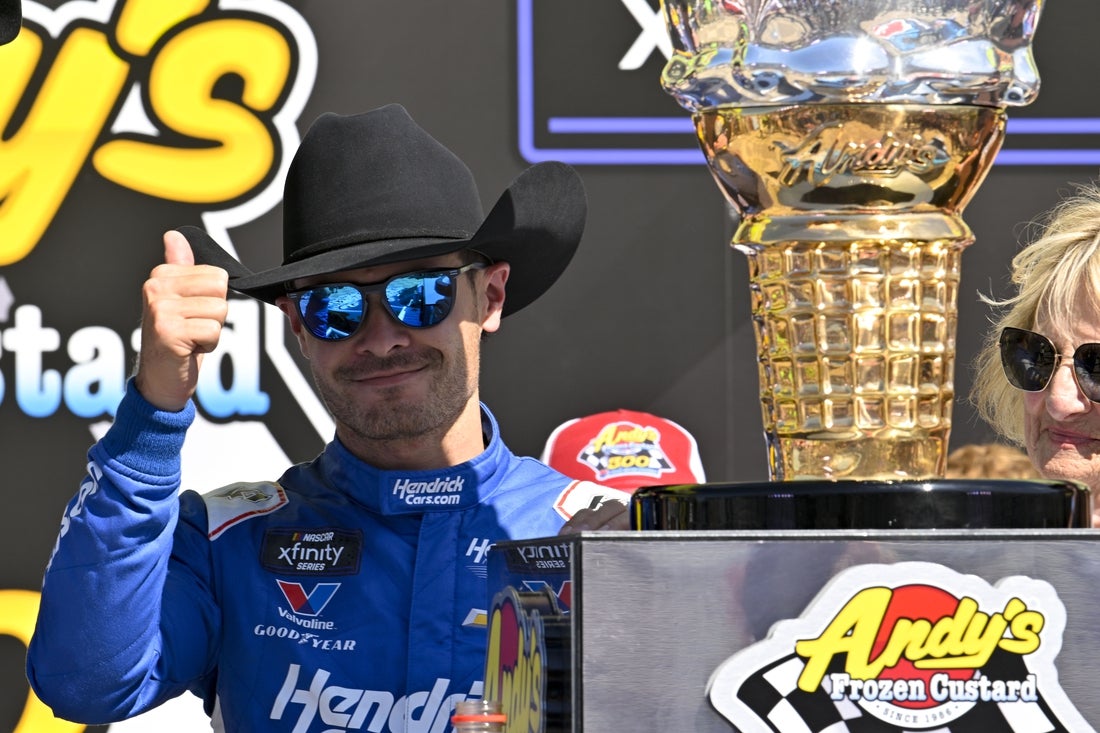 May 3, 2025; Fort Worth, Texas, USA; NASCAR Xfinity Series driver Kyle Larson (88) tries on a cowboy hat in Victory Lane after he wins the NASCAR Xfinity race at Texas Motor Speedway. Mandatory Credit: Jerome Miron-Imagn Images