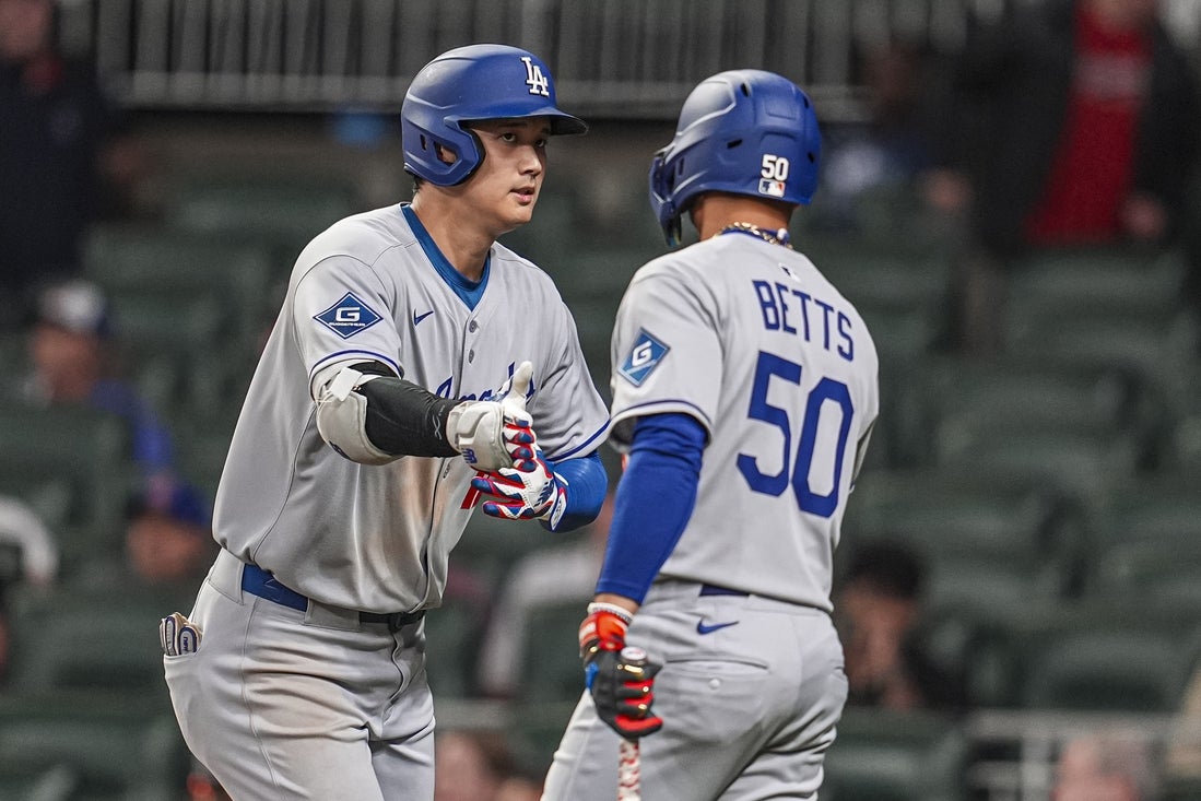 May 3, 2025; Cumberland, Georgia, USA; Los Angeles Dodgers designated hitter Shohei Ohtani (17) reacts with shortstop Mookie Betts (50) after hitting a home run against the Atlanta Braves during the third inning at Truist Park. Mandatory Credit: Dale Zanine-Imagn Images