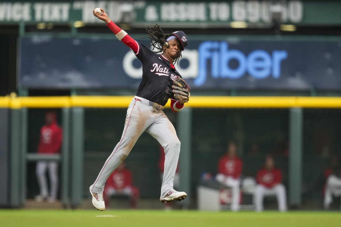 May 4, 2025; Cincinnati, Ohio, USA; Washington Nationals shortstop CJ Abrams (5) fields the ball and attempts to throw out Cincinnati Reds outfielder Spencer Steer (7) in the fourth inning at Great American Ball Park. Mandatory Credit: Aaron Doster-Imagn Images